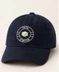 Navy blue cap with 'FETA IS BETTER' logo on a light beige background